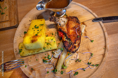 Wallpaper Mural Grilled chicken piece, polenta and asparagus on circle wooden board. Torontodigital.ca