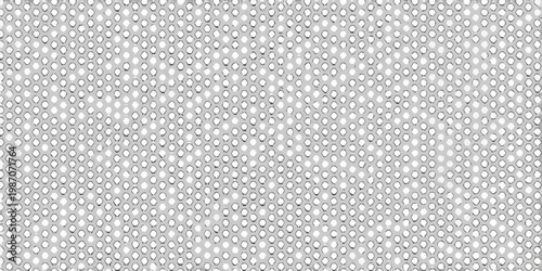 Close up of a perforated metal sheet with a repeating hole pattern