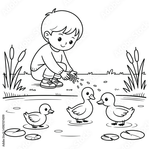 A young boy lovingly feeds a handful of seeds to three ducklings by a pond silhouette