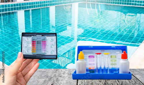 Water tester test kit in girl hand over blurred swimming pool water background, quality water testing test kit, pool maintenance and service business concept