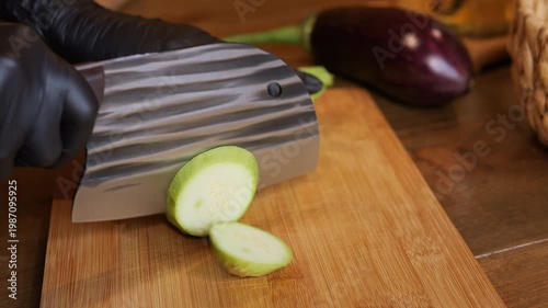 Kitchen hygiene and safety during cooking chef hands in gloves using sharp knife for precise cutting Cooking process highlights clean workflow preventing contamination and safe meal preparation