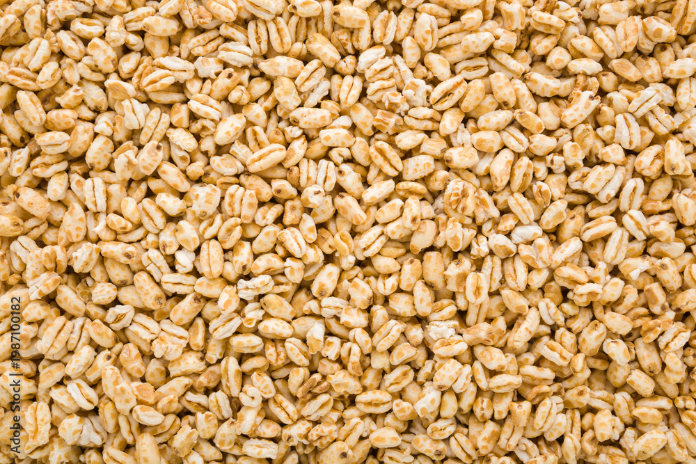Fototapeta premium Yellow dry puffed wheat flakes background. Closeup. Top down view.