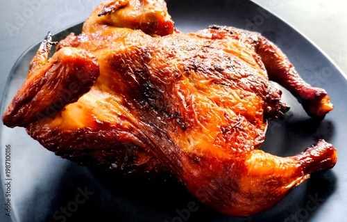 Grilled chicken on plate, top view indooe Chiangmai Thailand.