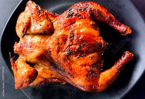 Grilled chicken on plate, top view indooe Chiangmai Thailand.