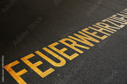 Orange letters of fire brigade access emergency area for driving.