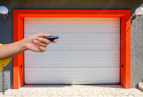 Garage door PVC. Hand use remote controller for closing and opening garage door
