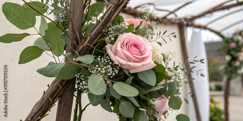 Pink rose and eucalyptus floral arrangement on wedding arch with wedding decor, eucalyptus