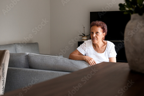 Portrait of senior hispanic woman relaxing in living room