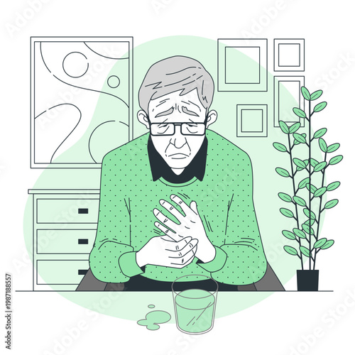 Elderly man with parkinsons disease holding his shaking hands while sitting at a table