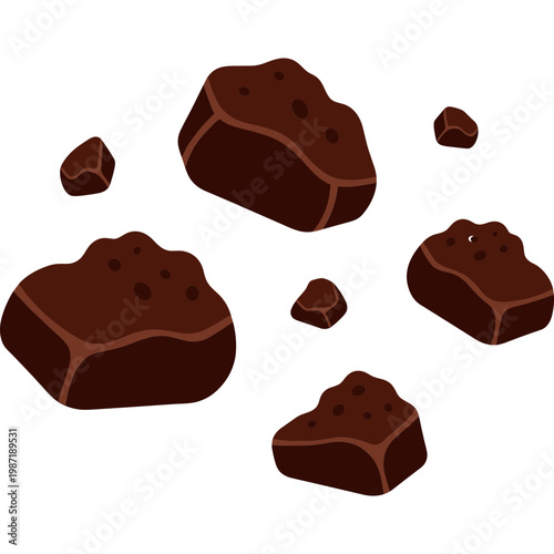 Chocolate chunks and pieces scattered on a table top surface