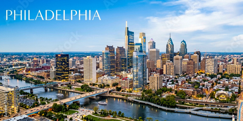 Iconic Philadelphia skyline featuring the Schuylkill River, bridges, and tall skyscrapers under a bright blue sky