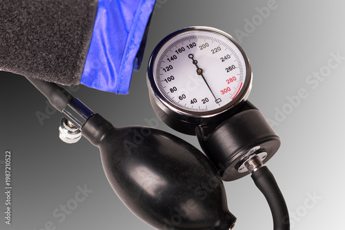 Medical equipment for measuring blood pressure with a gauge and cuff on a white background