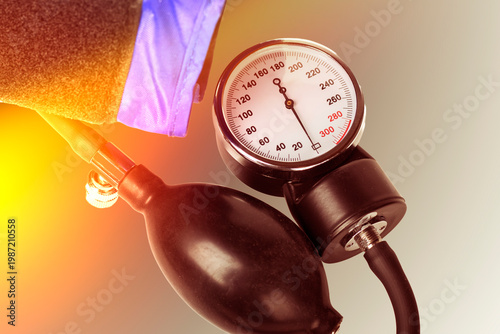 Medical equipment for measuring blood pressure with a gauge and cuff on a white background