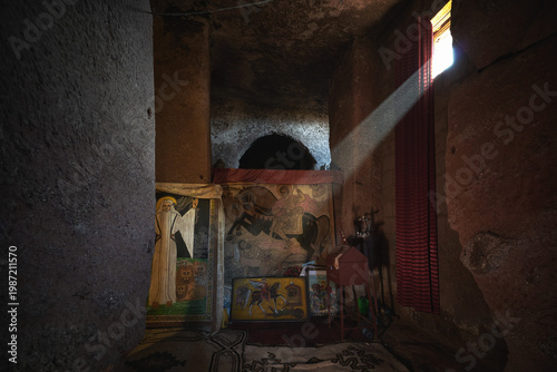 Fotografie Ray of sunlight illuminating ancient icons inside a rock-hewn church in Lalibela