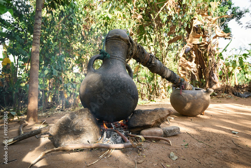 Bild auf Leinwand Rural  Ethiopian distillation process of homemade alcohol Areke