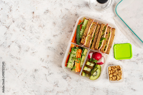 Clean eating lunchbox with fresh vegetables fruit and nuts