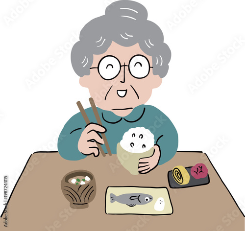 おばあさんがお箸を持って日本食のご飯を食べている2