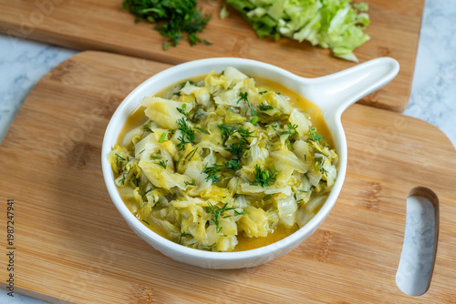 Stewed young cabbage with butter and dill