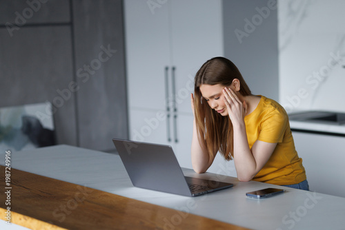 Vertical portrait of woman overworked exhausted of use a laptop, having stress headache.