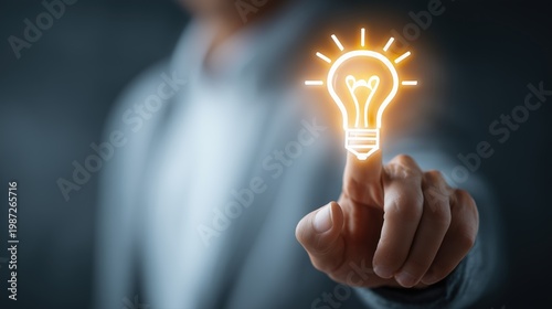 Businessman touching a glowing light bulb on a virtual screen, an idea and innovation concept.