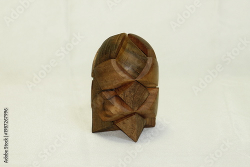 Foto Handmade Wooden Burr Puzzle Brain Teaser Toy Isolated on White Background