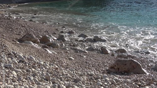 Kas, Turkey - 24 of February 2026: Sea waves washing over white pebbles on Buyukcakil beach
