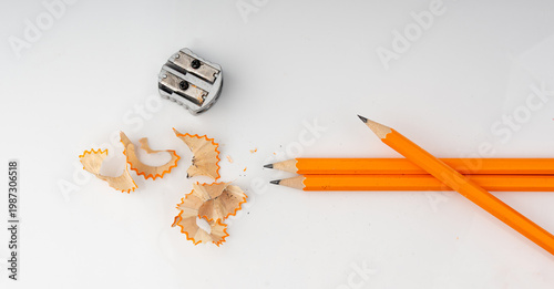 Sharpening pencils isolated. Yellow wooden graphite pencils with erasers, pencil shavings
