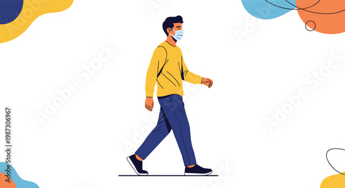 Young man wearing a yellow sweater and blue pants walking while wearing a protective face mask for safety and health.