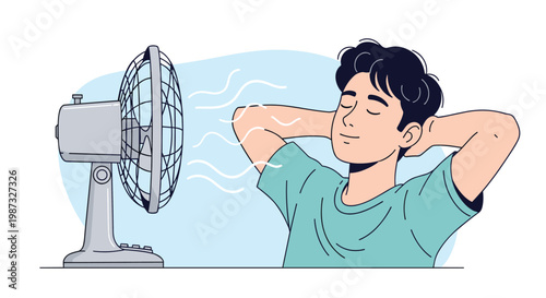 Happy young man closing eyes and relaxing in front of electric desk fan to cool down and get relief during hot summer day at home.