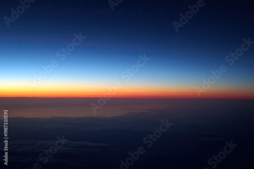Aerial view of horizon at twilight, gradient sky, clouds below