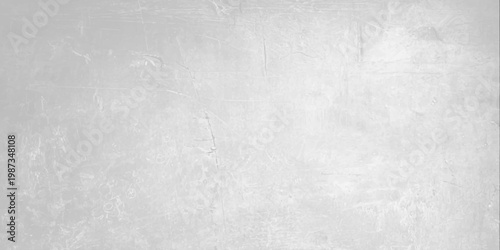 A dark grey brushed metal texture with a grunge pattern on an old rough surface creates a vintage aged backdrop for a textured industrial design. Light gray concrete wall texture background