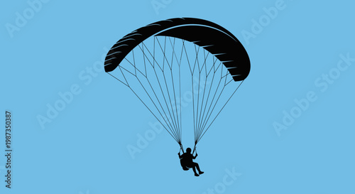 Silhouette Of A Person Paragliding Against A Clear Blue Sky