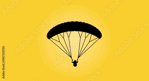Silhouette Paraglider Soaring Against Vibrant Yellow Sky
