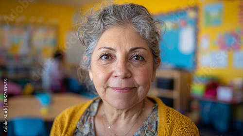 A warm smiling older woman looks directly at the camera.