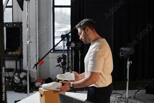 Εκτύπωση καμβά Passionate professional capturing shoe beauty during a creative indoor photoshoo