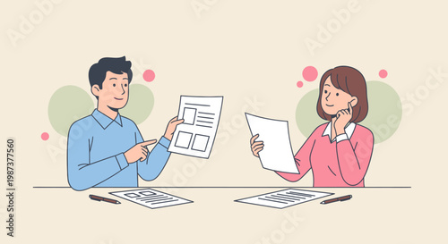 Two colleagues discussing documents at a table.