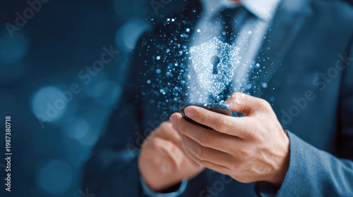 Cybersecurity concept with businessman holding smartphone displaying glowing digital shield with keyhole for data protection.