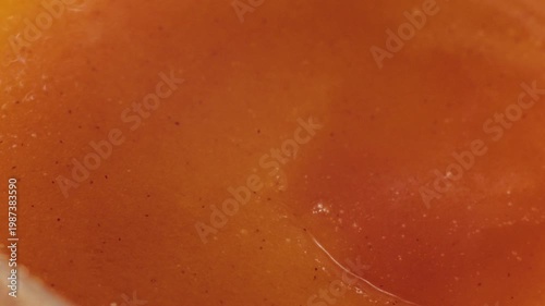 Highquality shot capturing juicy apricot surface and textures. Photograph emphasizing glistening juice and porous texture of freshly picked apricot