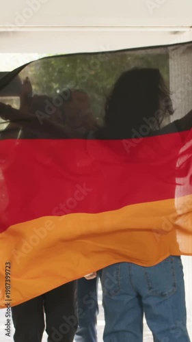 Vertical video: Entering casual trio greeting host at door, spreading flag with phone, drinks