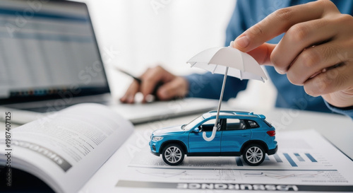 insurance, car, policy, coverage, claim, A miniature car with an umbrella on insurance documents symbolizes car insurance policy, financial protection, and risk coverage for vehicles and drivers. 