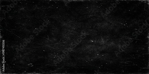 Aged black and white grunge background with a dark textured surface of old concrete wall and vintage chalk blackboard pattern for a blank rough design backdrop
