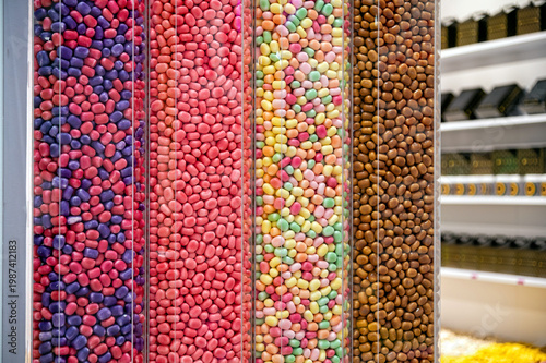 Colorful candies displayed in clear containers at a candy shop in the afternoon