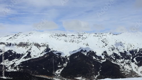 Snow-capped mountain peaks and coniferous trees.
