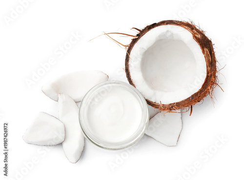 Fotografie Delicious coconut yogurt in glass jar and pieces of fruit isolated on white, top