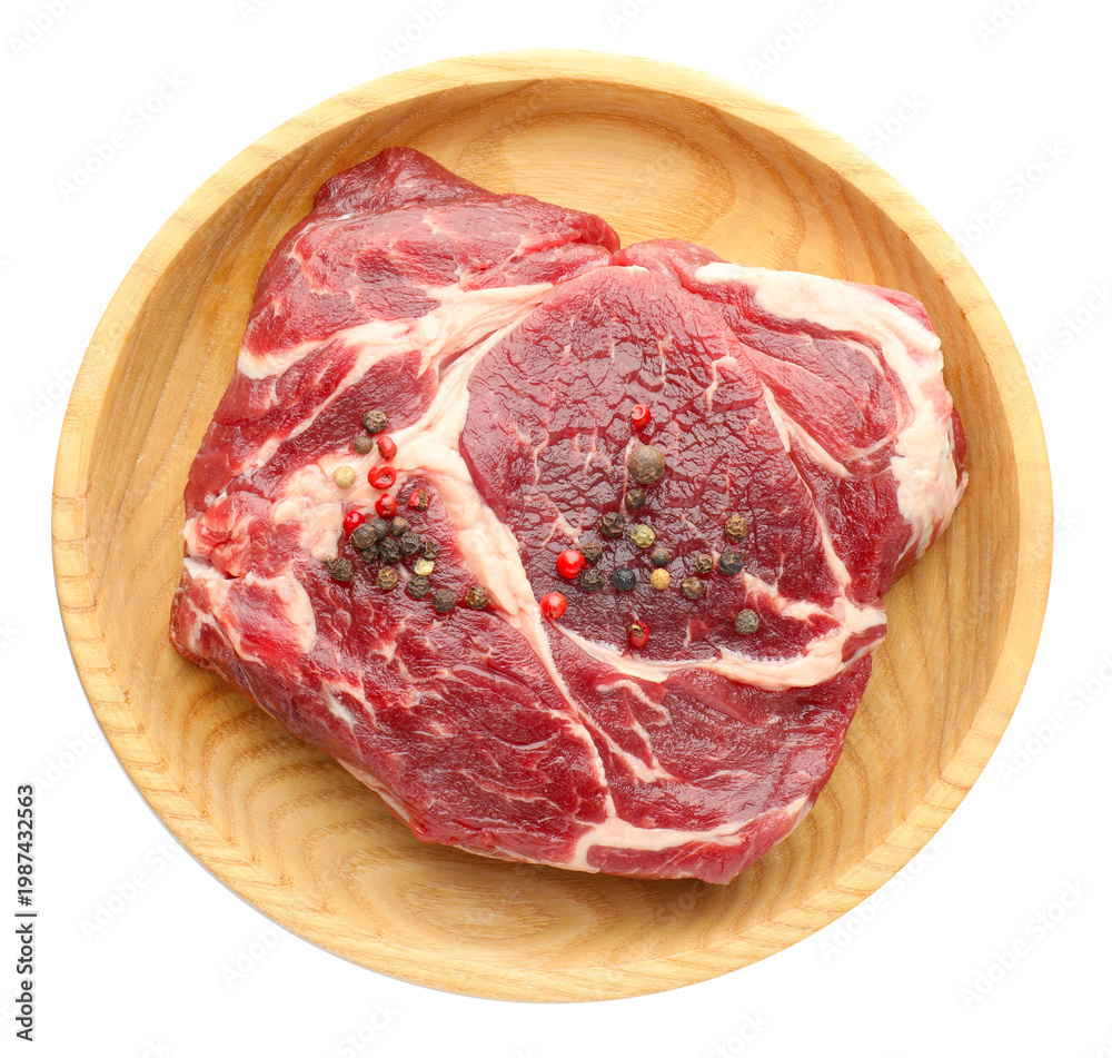 Obraz premium Raw ribeye beef steak and peppercorns isolated on white, top view
