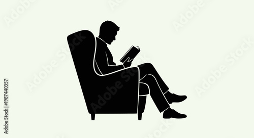 Silhouette of a man reading a book while sitting in an armchair.