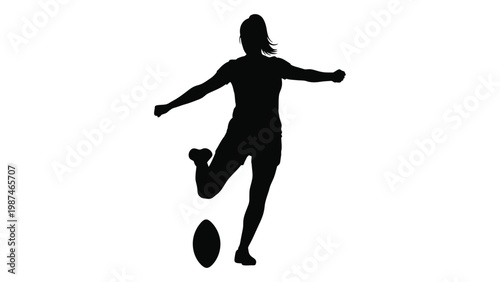A silhouette of a woman kicking a football showcasing dynamic athletic movement