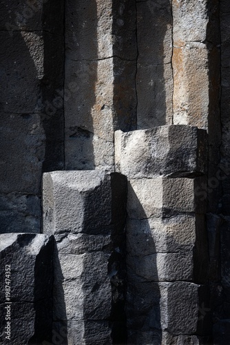 Textures and shadows dance on ancient stone formations in a mysterious, dimly lit cave during the quiet hours of dawn