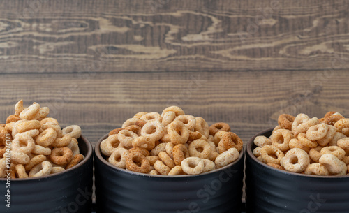 whole wheat cheerios in a bowls wooden background