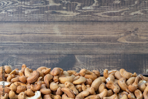roasted salted cashews wooden background